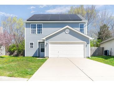 Charming home featuring solar panels, a two-car garage, and well-maintained landscaping at 7010 Beargrass Ct, Indianapolis, IN 46241