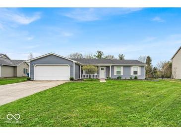 Charming single-story home with a well-manicured lawn and attached two-car garage at 9328 Haddington W Dr, Indianapolis, IN 46256