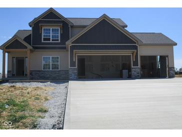 Two-story home featuring mixed siding and a large concrete driveway at 1426 Redwood Dr, Crawfordsville, IN 47933