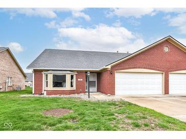 Charming brick home with an attached two-car garage and well-maintained front lawn at 229 Waterford Ct, Avon, IN 46123