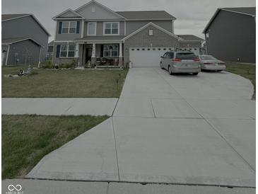 Charming two-story home featuring a brick and siding facade, well-manicured lawn and a spacious driveway at 280 Walker Dr, Whiteland, IN 46184