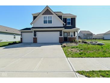 Two story home with a three car garage and a well manicured lawn at 321 Bluestem Ln, Whiteland, IN 46184