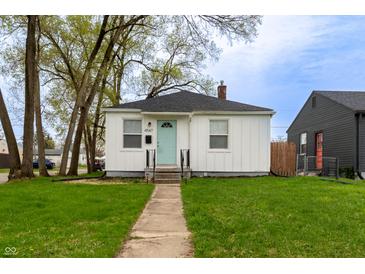Charming single-story home featuring a neatly manicured front yard, complemented by a light blue front door at 4547 Farrington Ave, Indianapolis, IN 46201