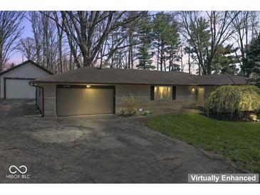 Charming home with attached garage, well-maintained lawn, and mature trees at 10129 Guilford Ave, Carmel, IN 46280