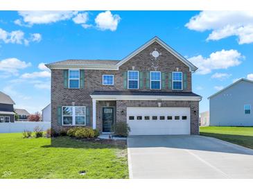 Charming two-story brick home with a well-manicured lawn and a two-car garage at 10465 Long Branch Dr, Brownsburg, IN 46112