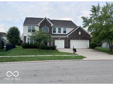 Traditional two-story home featuring a brick facade, attached two-car garage and well-manicured lawn at 1272 Southlake E Ave, Greenwood, IN 46143