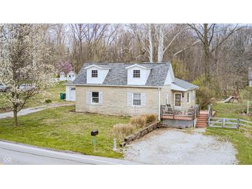 Charming one-story home featuring a cozy front porch and well-maintained yard, nestled in a serene wooded setting at 1527 N Washington St, Danville, IN 46122