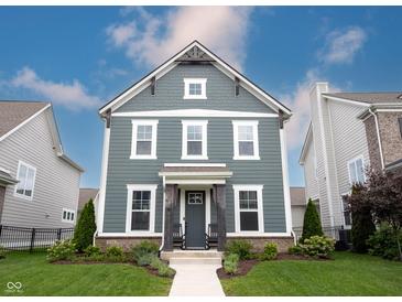 Charming two-story home with a blue-gray exterior, inviting front porch, and manicured lawn at 1534 Cloverdon Dr, Westfield, IN 46074