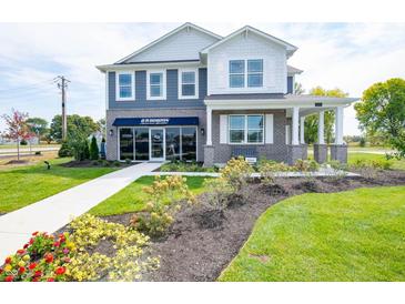 Charming two-story home with a beautifully landscaped yard and inviting front porch at 1571 Beyers St, Fortville, IN 46040