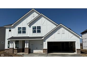 New construction featuring a white exterior, brick accents, an attached two-car garage and a covered porch entry at 18944 Seaforth Way, Westfield, IN 46074