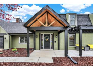 Charming home featuring a striking entryway with a custom wood-framed portico and a decorative front door at 2103 Postmaster Ln, Greenfield, IN 46140
