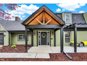 Charming home featuring a black front door with a wreath and a covered entrance with exposed wood beams at 2103 Postmaster Ln, Greenfield, IN 46140