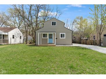 Charming home with a blue front door and a spacious green lawn at 2249 N Centennial St, Indianapolis, IN 46222