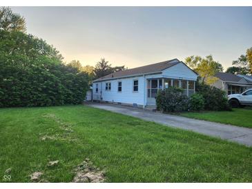 Charming single-story home with a well-maintained lawn and mature trees, offering a serene and inviting curb appeal at 2330 Harlan St, Indianapolis, IN 46203