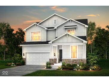 Charming two-story home featuring white siding, stone accents, and an attached two-car garage at 2747 Evergreen Ave, Plainfield, IN 46168