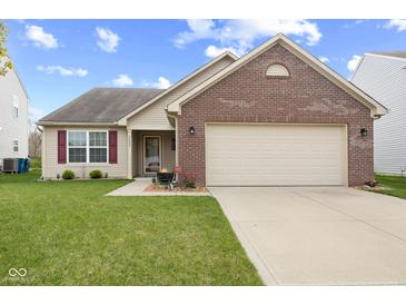 Charming single-story home featuring a brick facade, a well-manicured lawn, and an attached two-car garage at 3627 Miesha Dr, Indianapolis, IN 46217