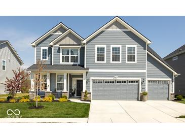 Charming two-story home featuring a three-car garage, complemented by a well-manicured lawn and mature landscaping at 5300 Veranda Dr, Noblesville, IN 46062