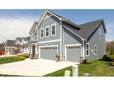 Beautiful two-story home showcasing a two-car garage, manicured lawn, and classic gray siding at 5300 Veranda Dr, Noblesville, IN 46062