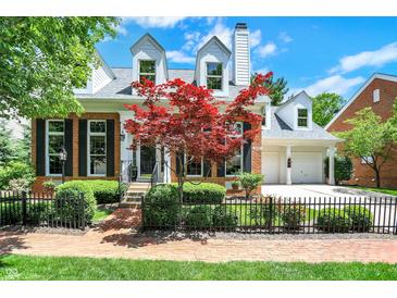 Charming brick home with a manicured front yard, black fence, and a beautiful red Japanese maple tree at 8089 Lynch Ln, Indianapolis, IN 46250