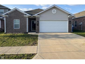 Charming single-story home with a brick facade, attached garage, and well-maintained lawn at 914 Baden Manor Dr, Indianapolis, IN 46217