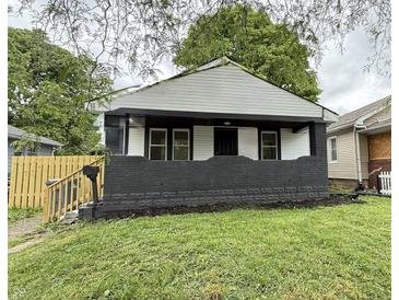 Charming home featuring a freshly painted exterior, well-maintained lawn, and quaint front porch at 1032 Groff Ave, Indianapolis, IN 46222
