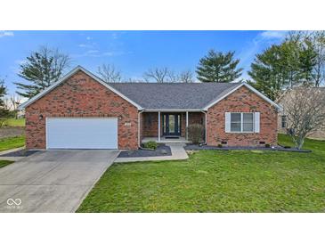 Charming red brick home with a well-manicured lawn, a two-car garage, and a welcoming front entrance at 2511 Countryside Westview Dr, Shelbyville, IN 46176