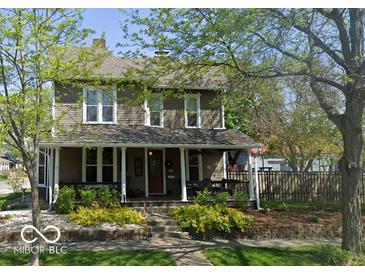 Charming two-story home with a welcoming front porch and manicured landscaping at 300 E Monroe St, Franklin, IN 46131