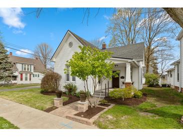 Charming home featuring meticulous landscaping and a cozy front porch at 350 W Pearl St, Greenwood, IN 46142