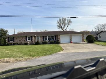 Charming brick ranch-style home featuring a two-car garage and well-maintained landscaping at 359 Anel Dr, Martinsville, IN 46151