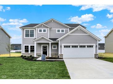 Charming two-story home featuring a two-car garage, stone accents, and a well-manicured lawn at 3727 Thomas Jefferson Ct, Westfield, IN 46074
