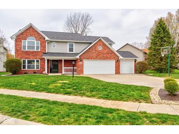 Charming two-story home with brick facade, attached two-car garage, and well-manicured lawn at 416 Concord Way, Greenwood, IN 46142