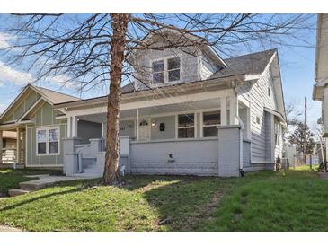 Charming two-story home with a cozy front porch and well-maintained lawn at 443 N Alton Ave, Indianapolis, IN 46222