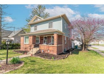 Charming two-story home with a brick facade, landscaped front yard, and inviting front porch at 504 S Lebanon St, Lebanon, IN 46052