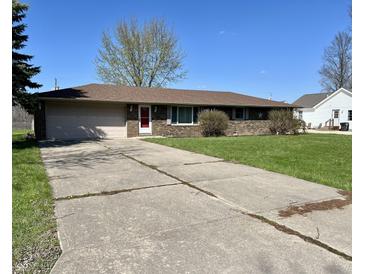 Charming brick home features a two-car garage and a well-maintained lawn at 508 E Hillside Dr, Anderson, IN 46011