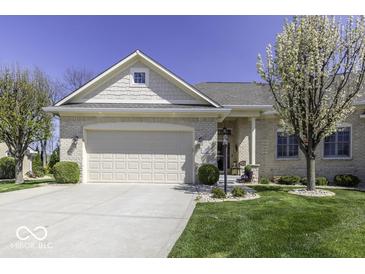 Charming single-story home featuring a well-manicured lawn, attached garage, and beautiful blossoming trees under a clear blue sky at 537 Weyworth Pl, Greenwood, IN 46142