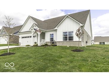 Charming single-Gathering home boasts a well-manicured lawn, stylish architectural details, and an attached two-car garage at 561 Riviera Pl, Greenwood, IN 46143