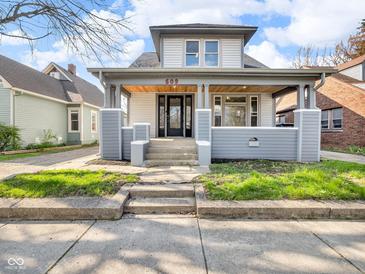 Charming two-story home with inviting front porch and well-maintained lawn at 609 E Southern Ave, Indianapolis, IN 46203