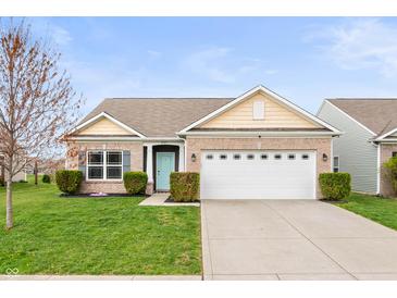 Charming brick home with a well-maintained lawn and two-car garage in a suburban neighborhood at 6323 Emerald Field Way, Indianapolis, IN 46221
