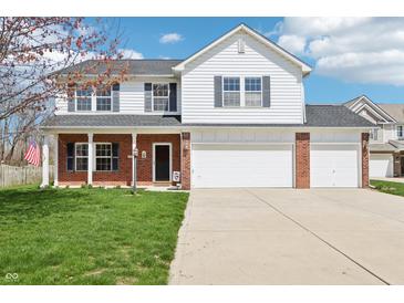 Charming two-story home with a well-manicured lawn, brick accents, and a two-car garage at 7354 Ponderosa Pines Ln, Indianapolis, IN 46239