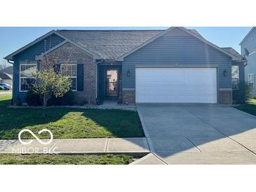 Charming single-story home with blue siding, brick accents, and a well-manicured front lawn at 8019 Gathering Ln, Indianapolis, IN 46259