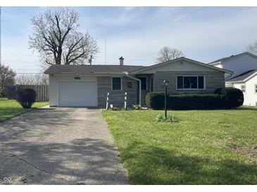 Charming single-story home with stone facade, attached garage, and well-maintained lawn at 9169 Hibben Ave, Indianapolis, IN 46229