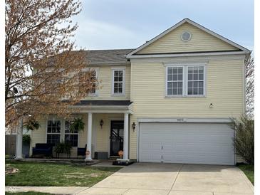 Charming two-story home featuring a light yellow exterior and a well-maintained front yard at 9873 Blue Ridge Way, Indianapolis, IN 46234