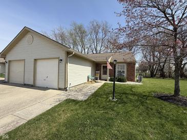 Charming single-story home with a well-maintained lawn, attached garage, and inviting entrance at 111 Woodberry Dr, Danville, IN 46122