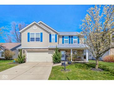 Charming two-story home with blue shutters, a well-maintained lawn, and a blossoming tree at 12258 Weathered Edge Dr, Fishers, IN 46037