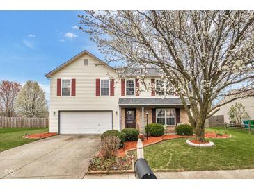 Charming two-story home with a well-manicured lawn, blossoming tree, and red-shuttered windows at 24 W Pine Ridge Dr, Westfield, IN 46074
