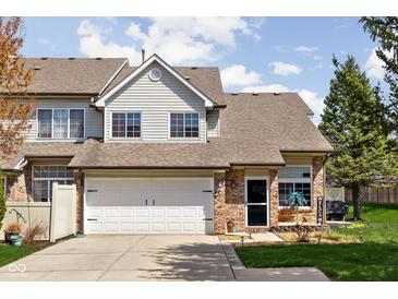 Charming townhome with a brick facade, well-maintained lawn, and a two-car garage at 253 Provincial Ln # Apt D, Avon, IN 46123