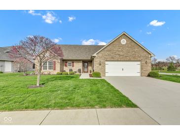 Charming brick home featuring a well-manicured lawn, flowering tree, and attached two-car garage at 2601 Viceroy Ln, Lebanon, IN 46052
