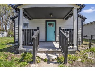 Inviting front porch featuring a vibrant blue door and classic black railings at 2631 Collier St, Indianapolis, IN 46241