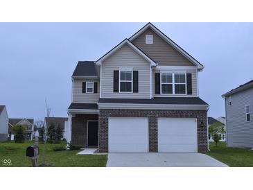 Charming two-story home featuring a brick-accented facade and a two-car garage at 3078 Creekridge Ct, Columbus, IN 47201