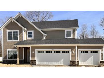 A craftsman style home with a two car garage, stone accents, and neutral toned horizontal and shake siding at 3818 Thomas Jefferson Ct, Westfield, IN 46074